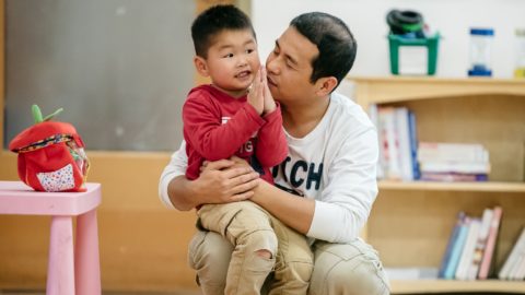 Dad with son on his knee