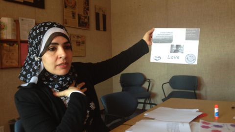 Woman holding up a training sign