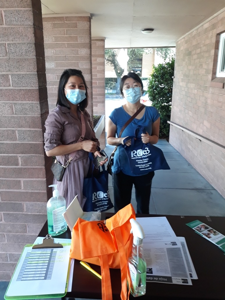 picture of two women with bags of personal protective equipment