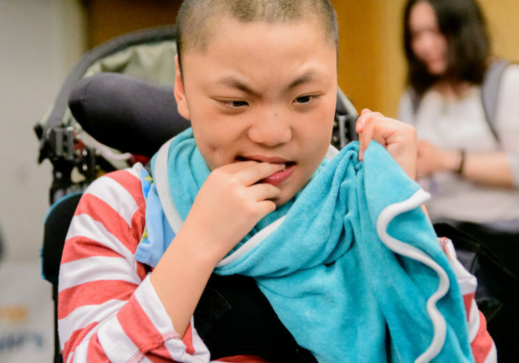 boy in wheelchair with towel